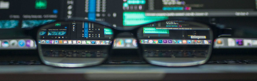 Eyeglasses in front of computer screens